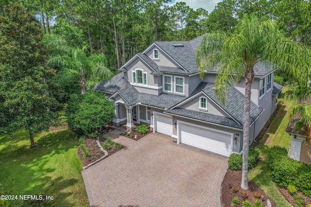 view of front of home with a front lawn and a garage