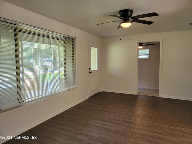 unfurnished room with dark hardwood / wood-style floors and ceiling fan