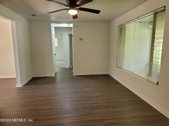 empty room featuring ceiling fan and dark hardwood / wood-style flooring