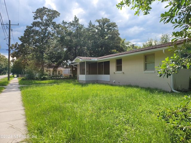 view of yard with a sunroom