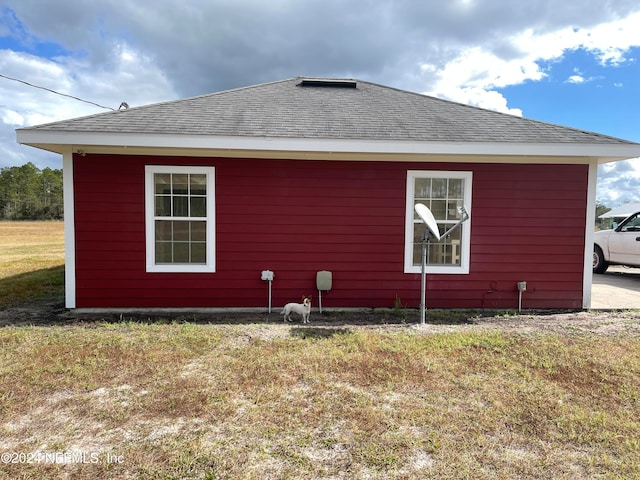 view of home's exterior with a yard