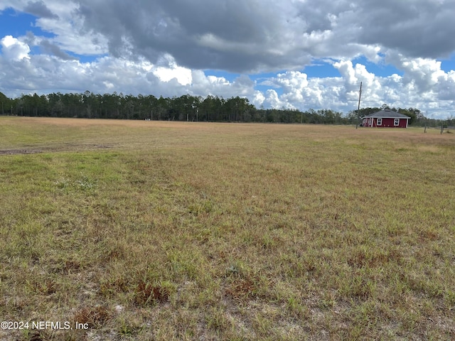 view of yard with a rural view