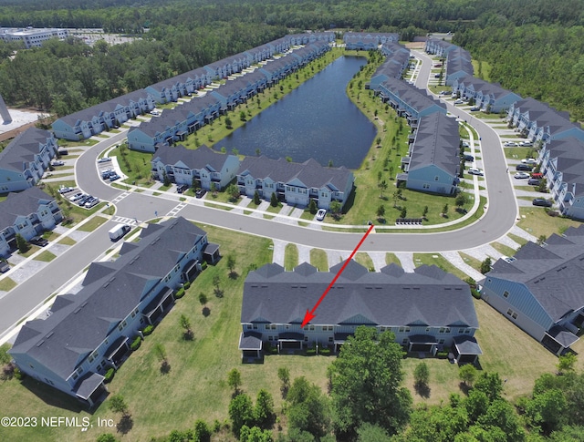 birds eye view of property with a water view and a residential view