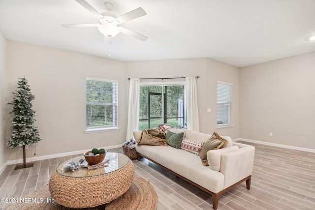 living room featuring ceiling fan and light hardwood / wood-style flooring