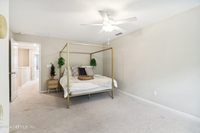 bedroom featuring ceiling fan and light carpet