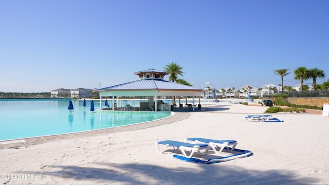 view of pool with a gazebo and a water view