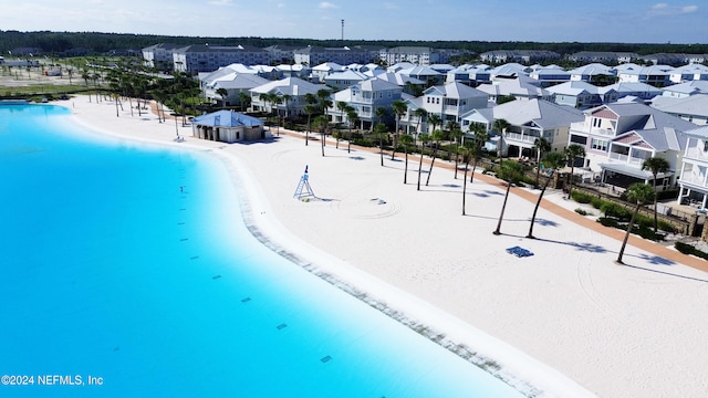 bird's eye view with a residential view and a beach view