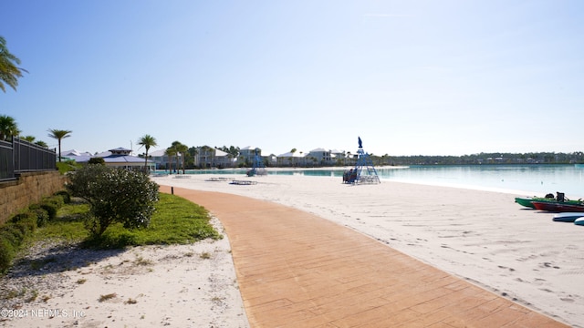 surrounding community featuring a water view and fence