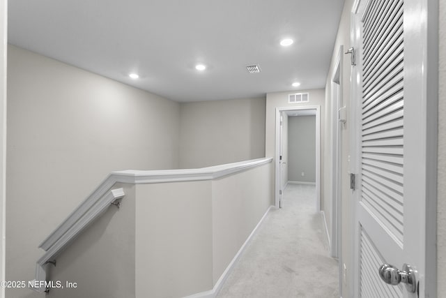 corridor with recessed lighting, carpet, visible vents, and an upstairs landing