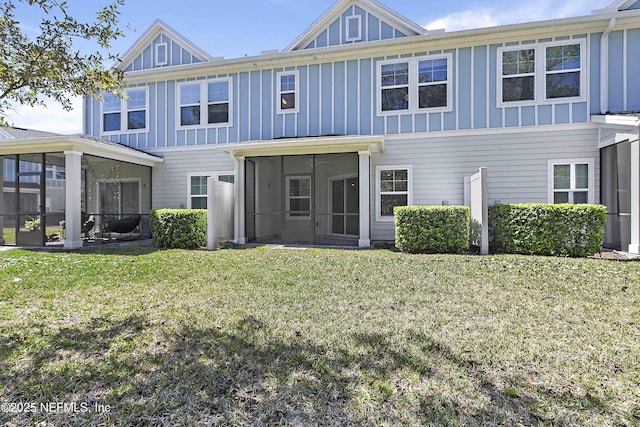 view of front of property with a front lawn, board and batten siding, and a sunroom