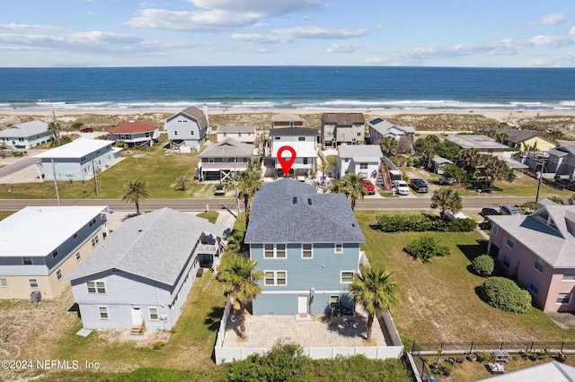 birds eye view of property with a view of the beach and a water view