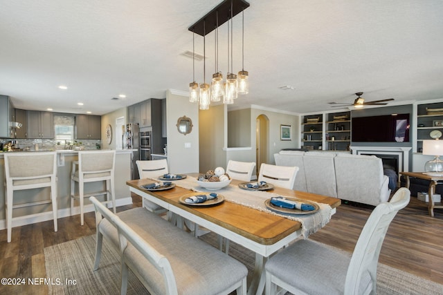 dining area with ornamental molding, dark hardwood / wood-style floors, a textured ceiling, and ceiling fan