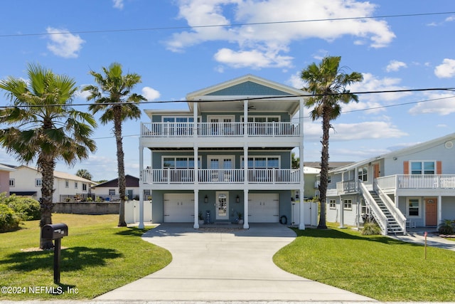 beach home featuring a front yard and a garage