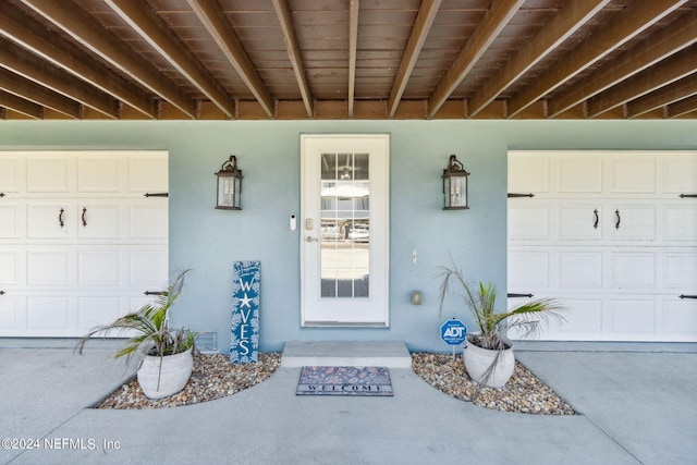 doorway to property with a garage