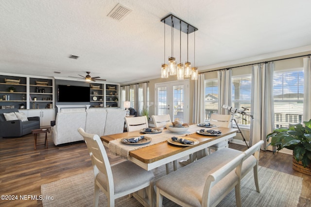 dining room with ceiling fan, a textured ceiling, and dark hardwood / wood-style floors