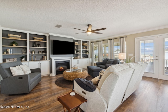 living room featuring french doors, dark wood-type flooring, crown molding, a textured ceiling, and ceiling fan