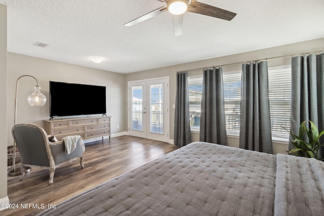 bedroom featuring ceiling fan, a textured ceiling, access to exterior, hardwood / wood-style flooring, and french doors