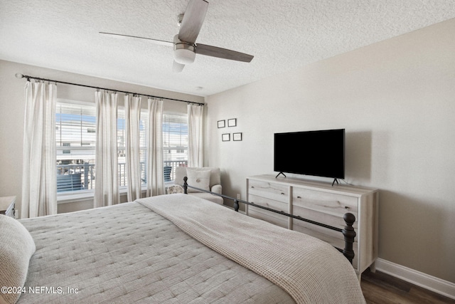 bedroom with ceiling fan, hardwood / wood-style flooring, and a textured ceiling