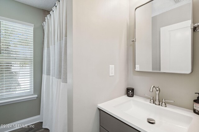 bathroom with vanity and hardwood / wood-style flooring