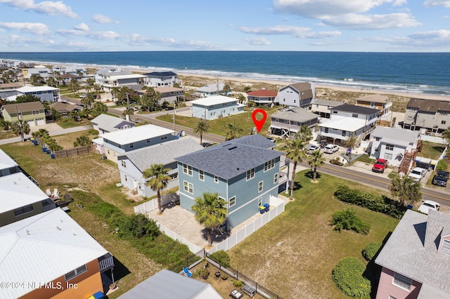 drone / aerial view featuring a water view and a beach view