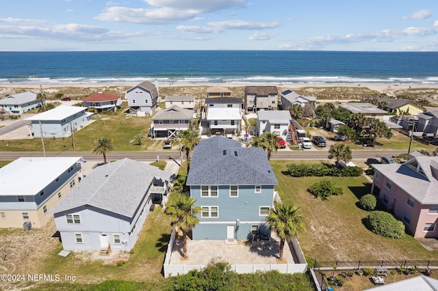 birds eye view of property featuring a view of the beach and a water view