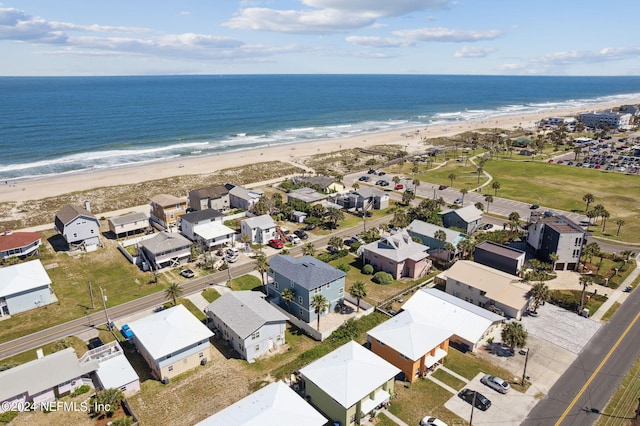 drone / aerial view with a water view and a view of the beach