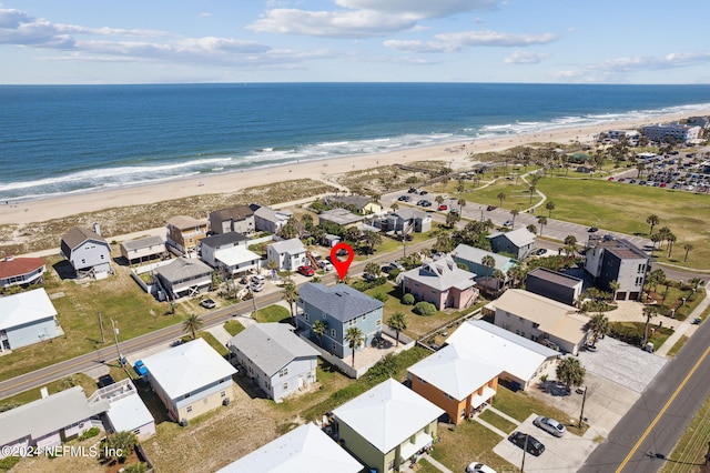 birds eye view of property featuring a water view and a view of the beach