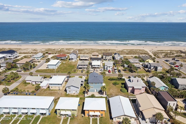 drone / aerial view with a water view and a beach view