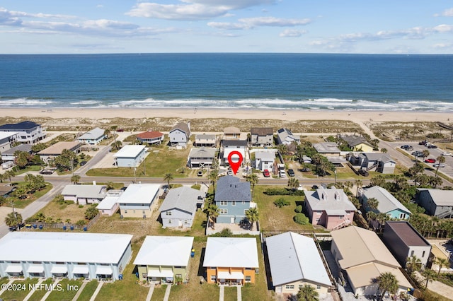 birds eye view of property featuring a water view and a view of the beach