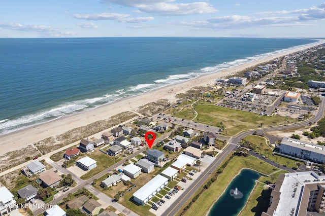 aerial view with a water view and a beach view