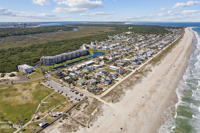 birds eye view of property with a water view and a beach view