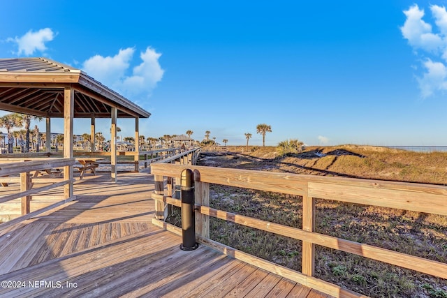 wooden terrace featuring a water view