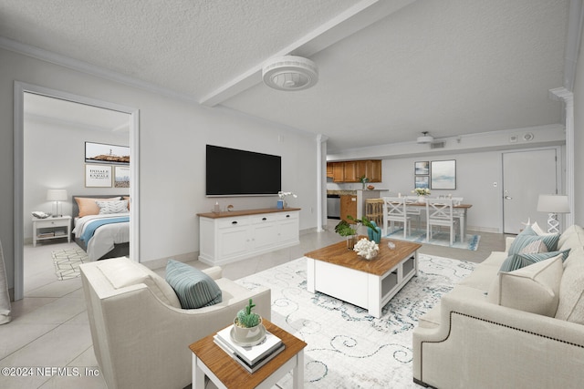 living room with a textured ceiling and light tile patterned floors