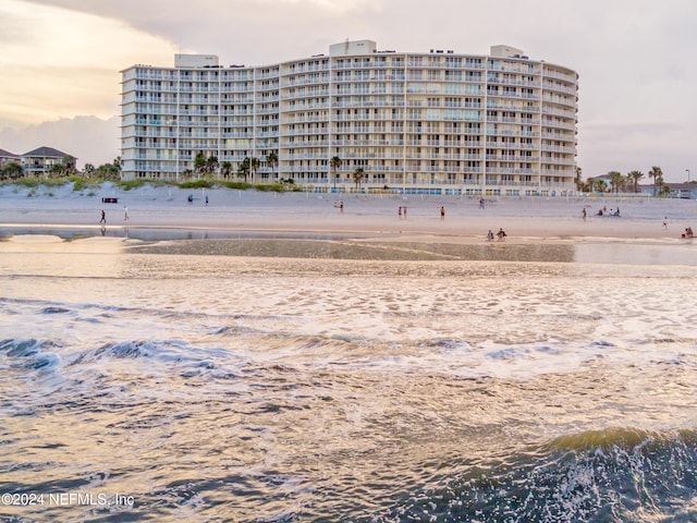 outdoor building at dusk with a water view and a beach view