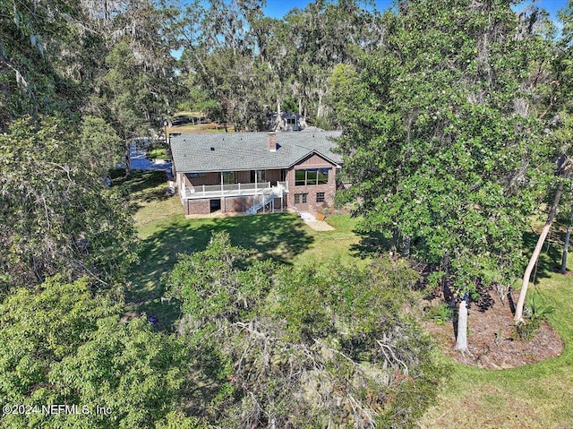 view of front of property featuring a front lawn and a deck