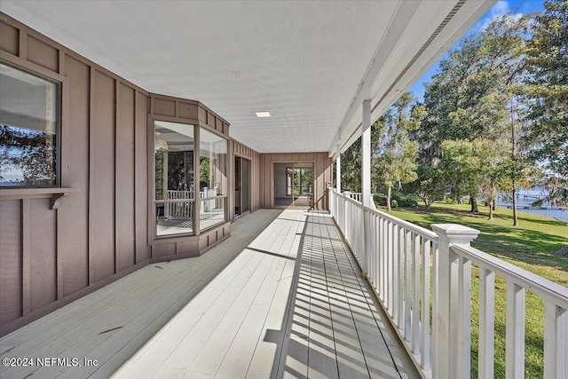 wooden terrace with a lawn