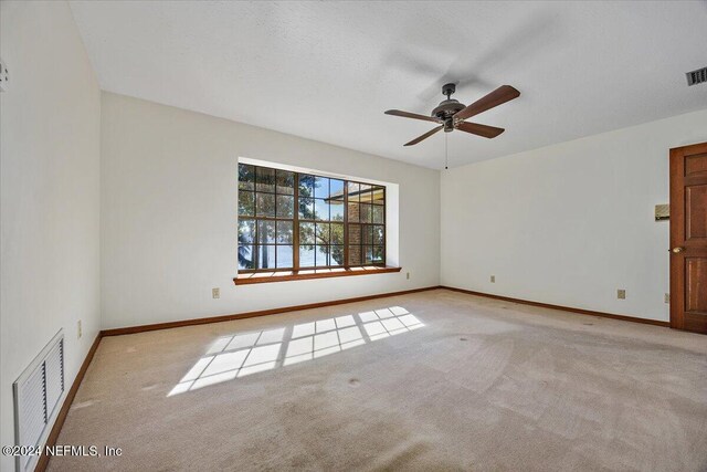 carpeted empty room with ceiling fan