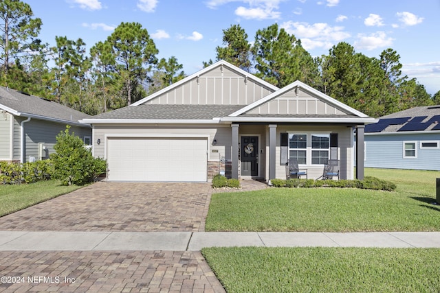 view of front of property with a garage and a front lawn