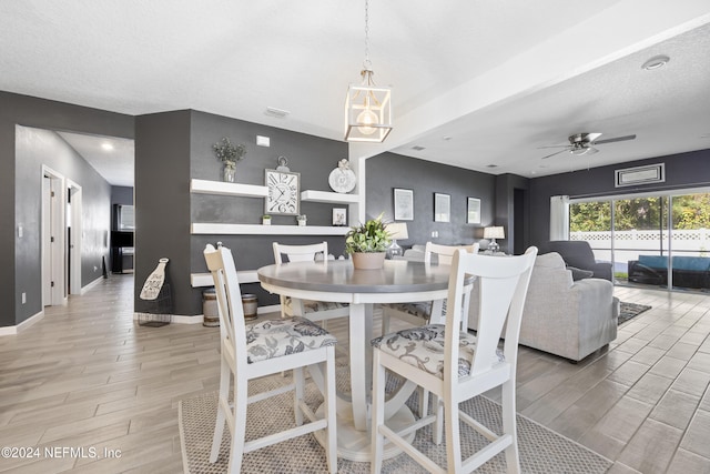 dining room featuring ceiling fan, wood-type flooring, and a textured ceiling