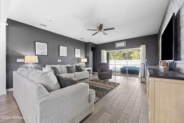 living room featuring light hardwood / wood-style floors and ceiling fan