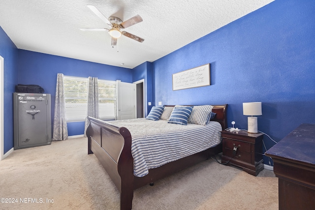 carpeted bedroom with a textured ceiling and ceiling fan