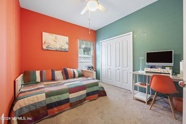 carpeted bedroom featuring a closet and ceiling fan