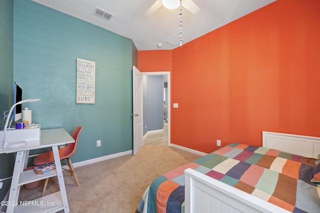 carpeted bedroom with a textured ceiling and ceiling fan