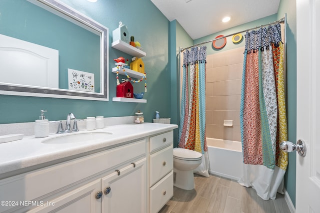 full bathroom featuring vanity, shower / tub combo with curtain, and toilet