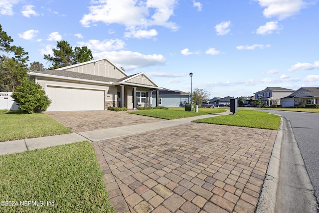 ranch-style house featuring a front yard and a garage