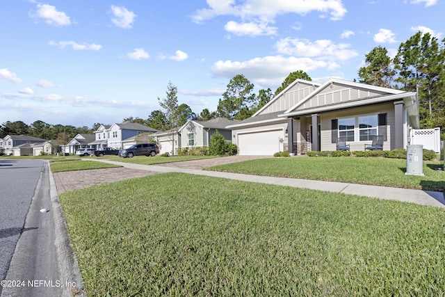 view of front of house with a garage and a front lawn