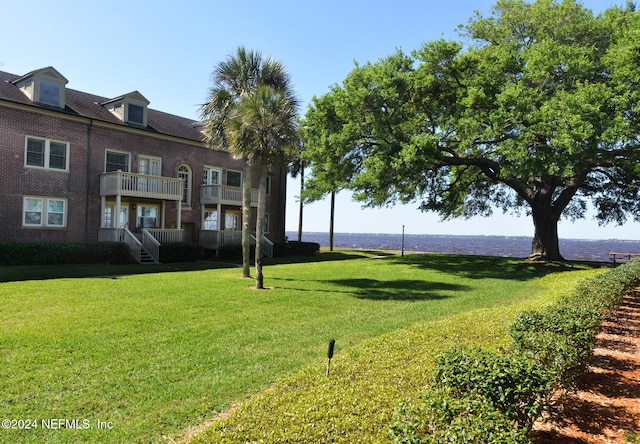 view of home's community with a yard