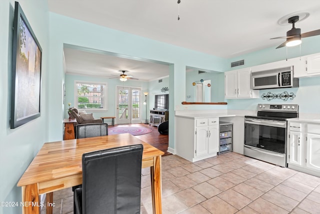 kitchen featuring white cabinets, stainless steel appliances, and ceiling fan