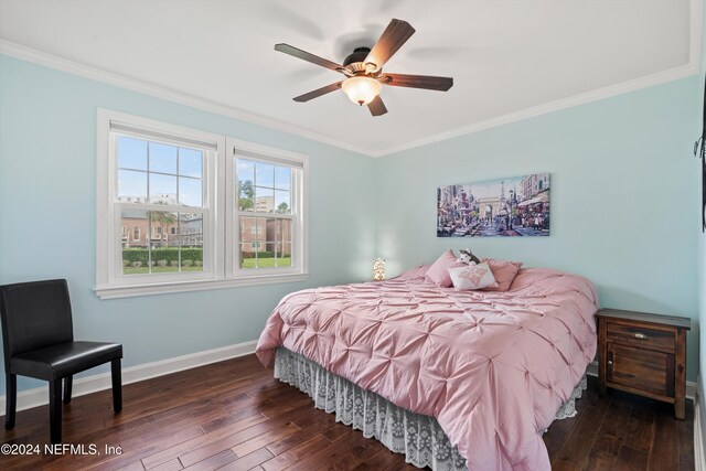 bedroom featuring dark wood-type flooring, ornamental molding, and ceiling fan