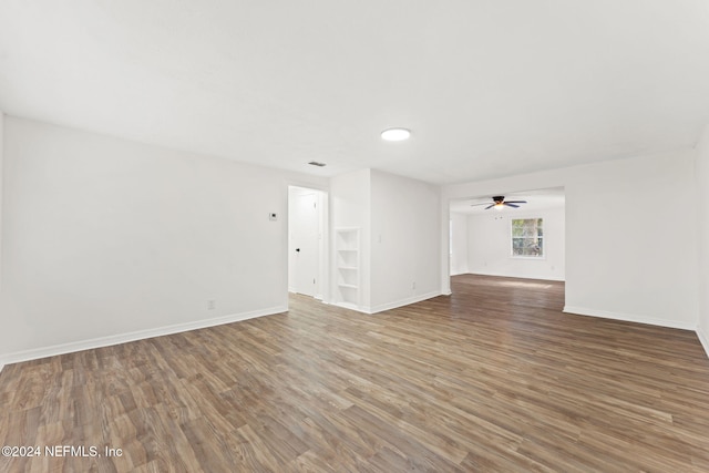 unfurnished living room featuring ceiling fan and hardwood / wood-style floors